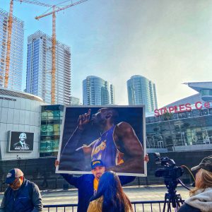 Picture outside the Staples Center of a fan holding a poster of Kobe Bryant